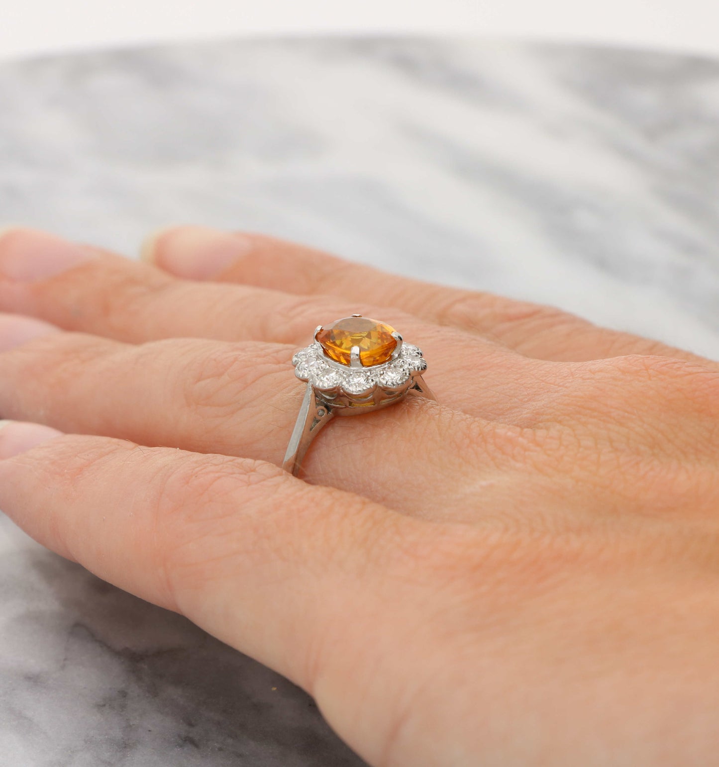Platinum orange sapphire and diamond cluster ring