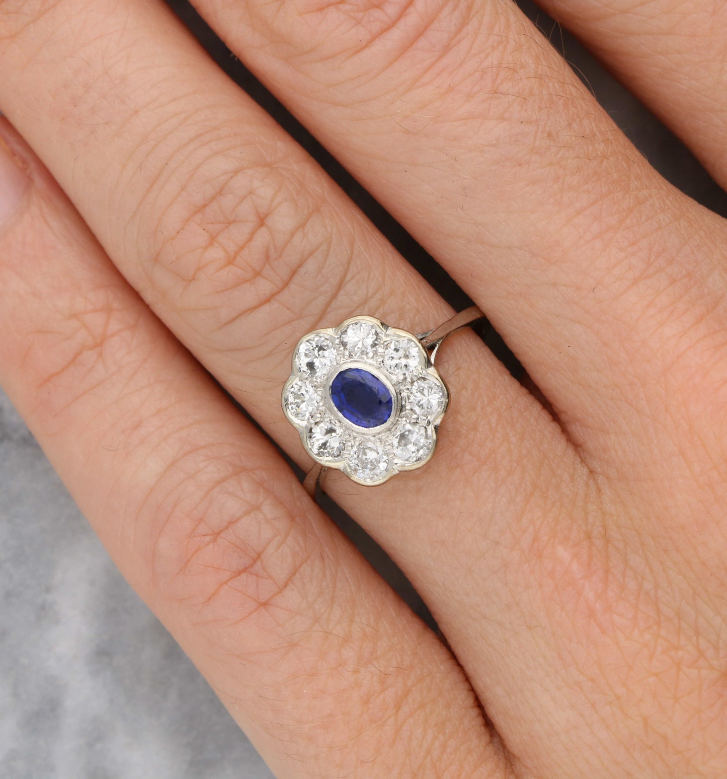 Sapphire and diamond cluster engagement ring