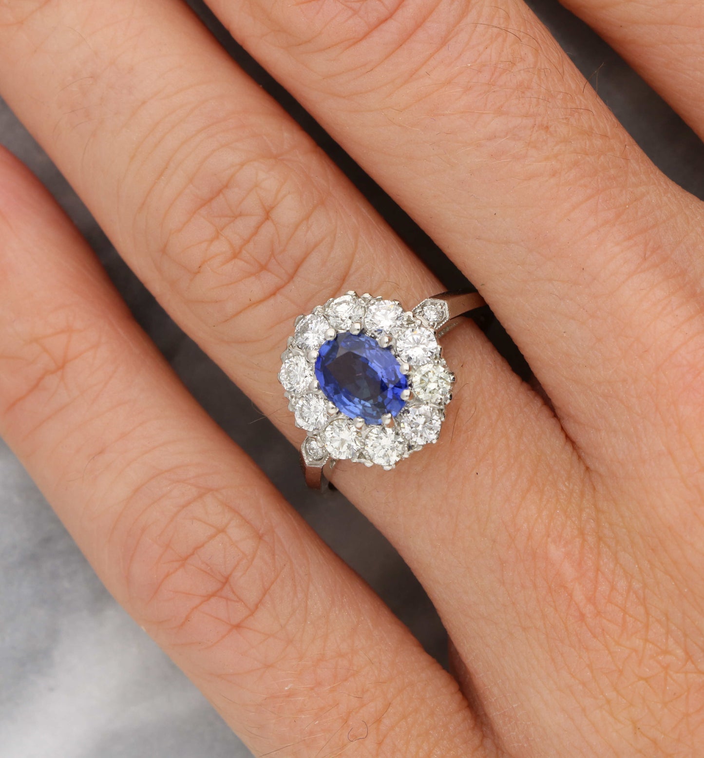 Platinum sapphire and diamond cluster engagement ring