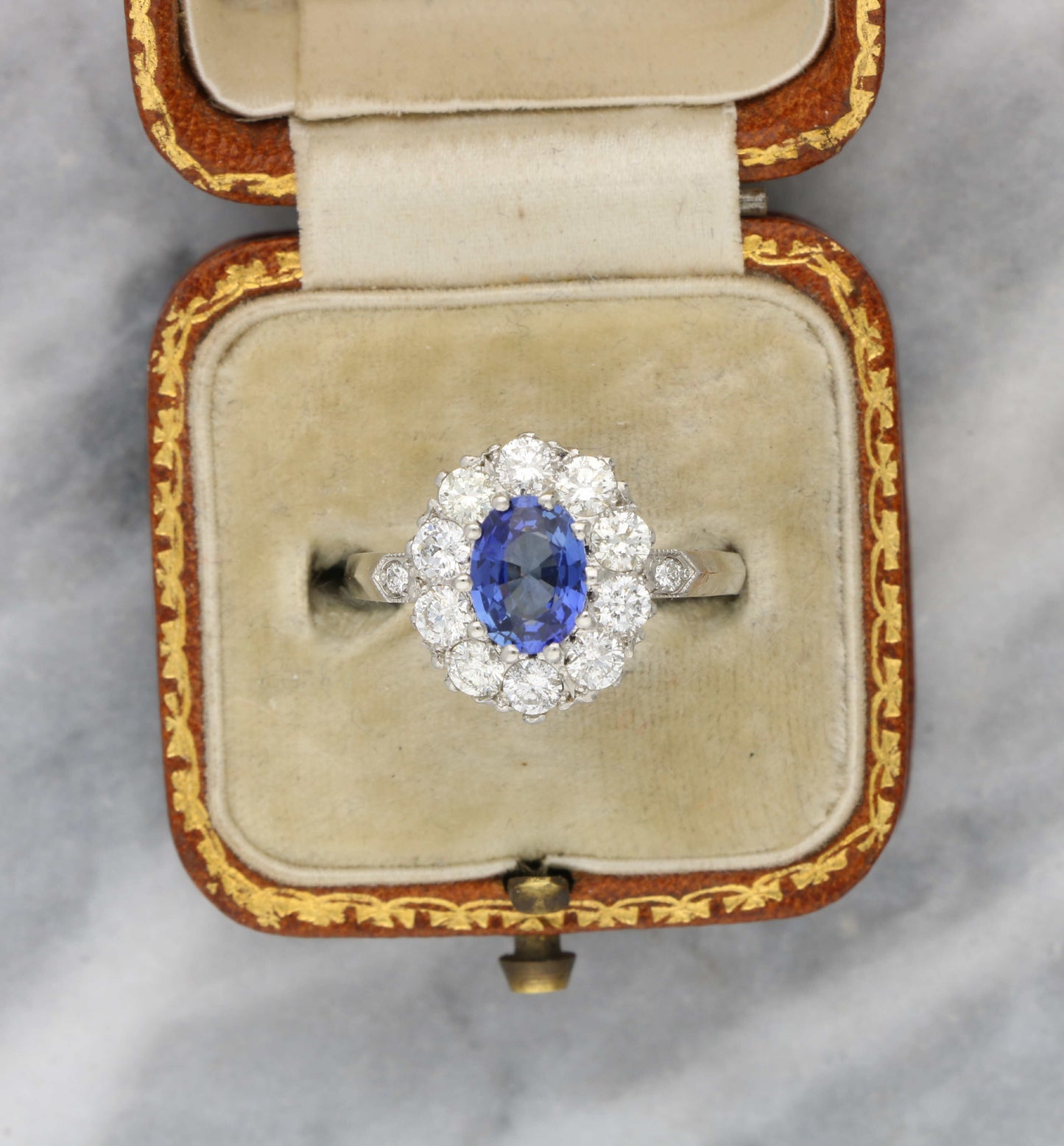 Platinum sapphire and diamond cluster engagement ring