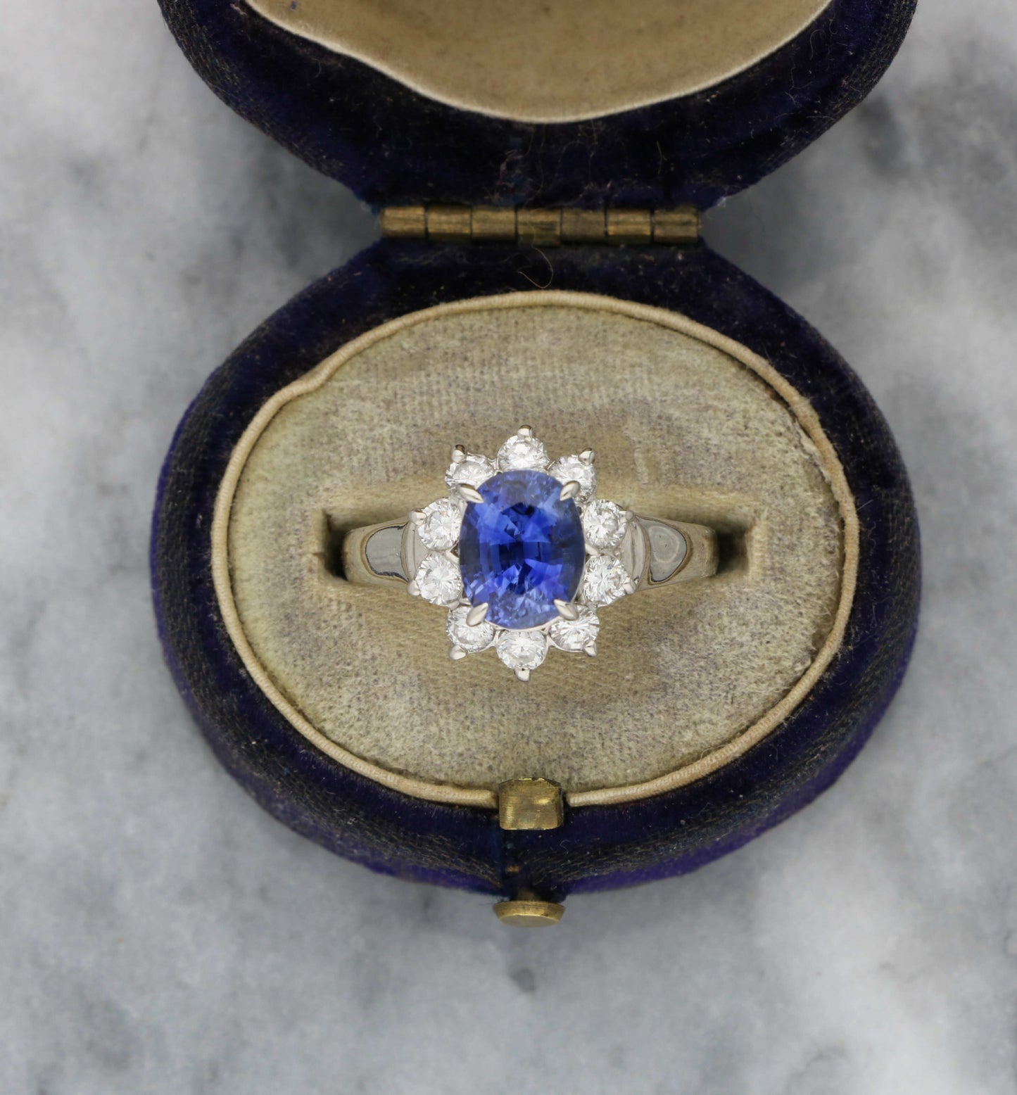 Platinum sapphire and diamond cluster engagement ring