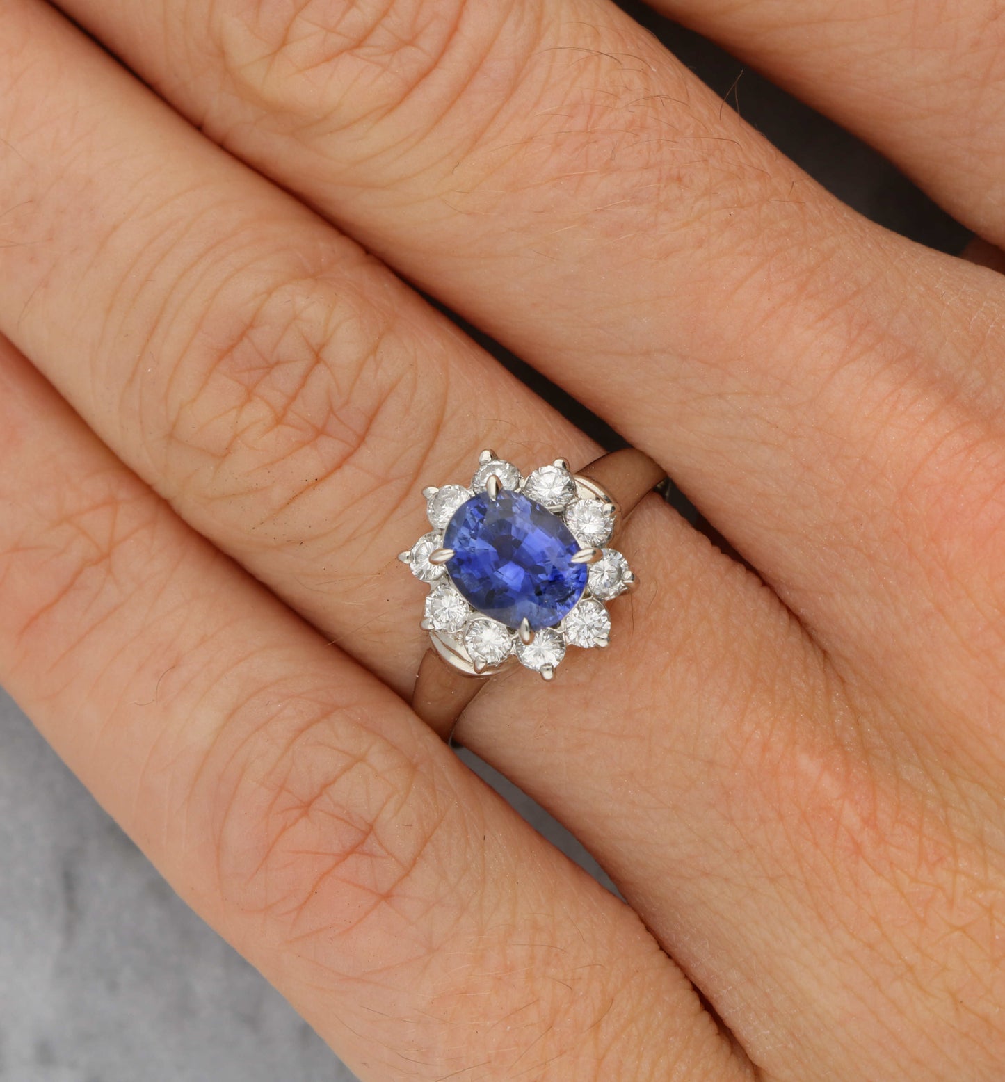 Platinum sapphire and diamond cluster engagement ring