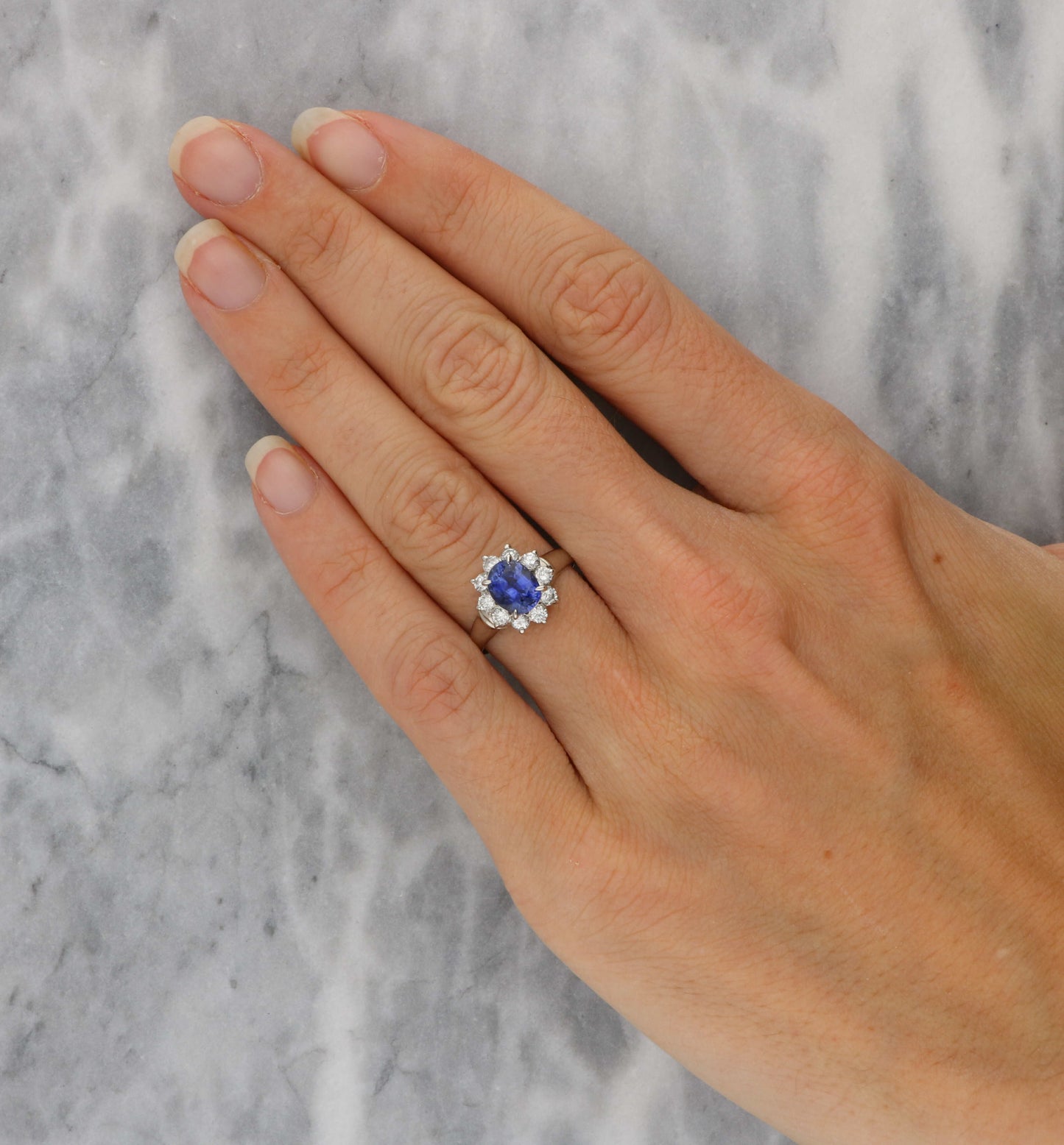 Platinum sapphire and diamond cluster engagement ring