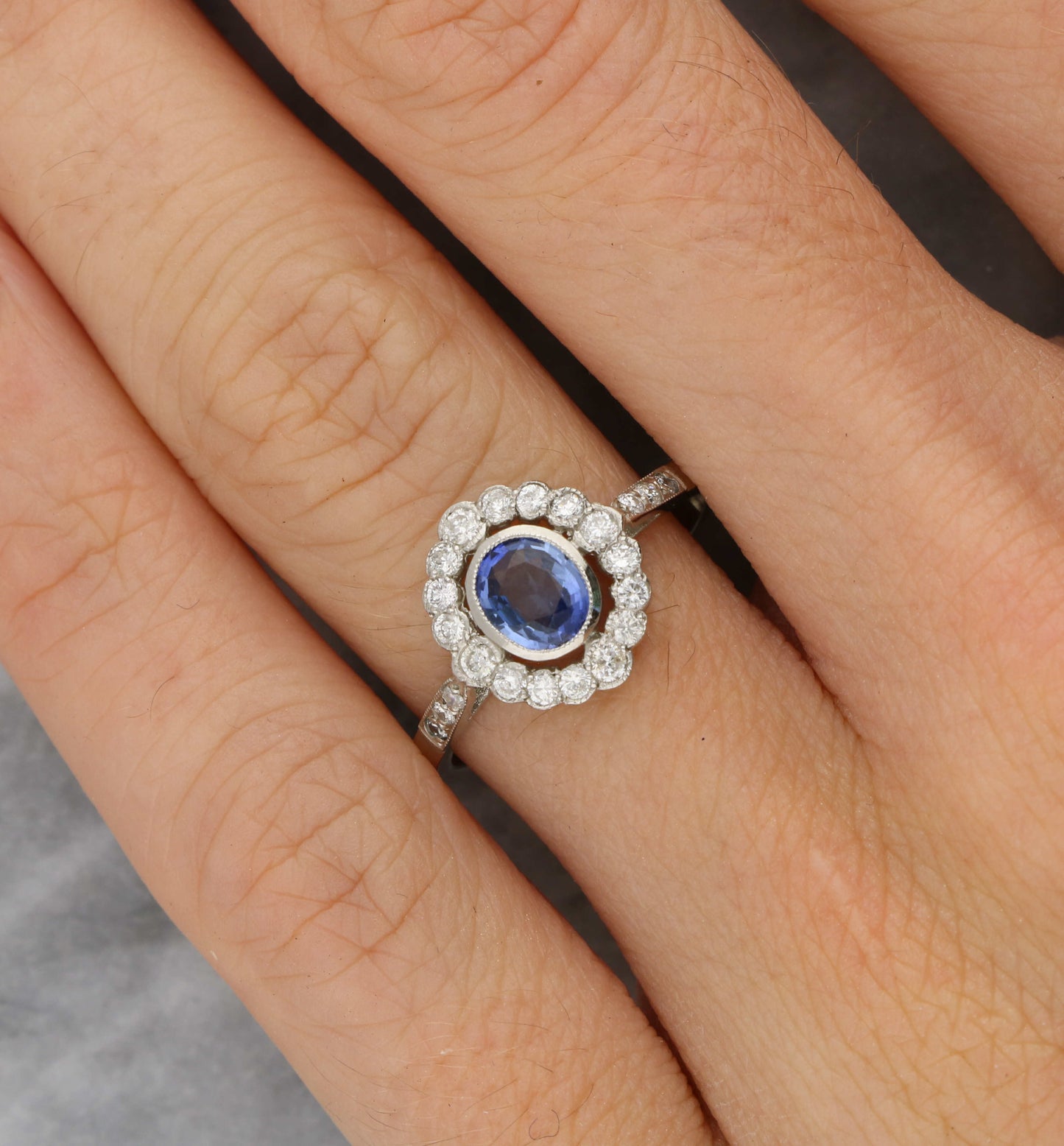 Platinum sapphire and diamond cluster engagement ring
