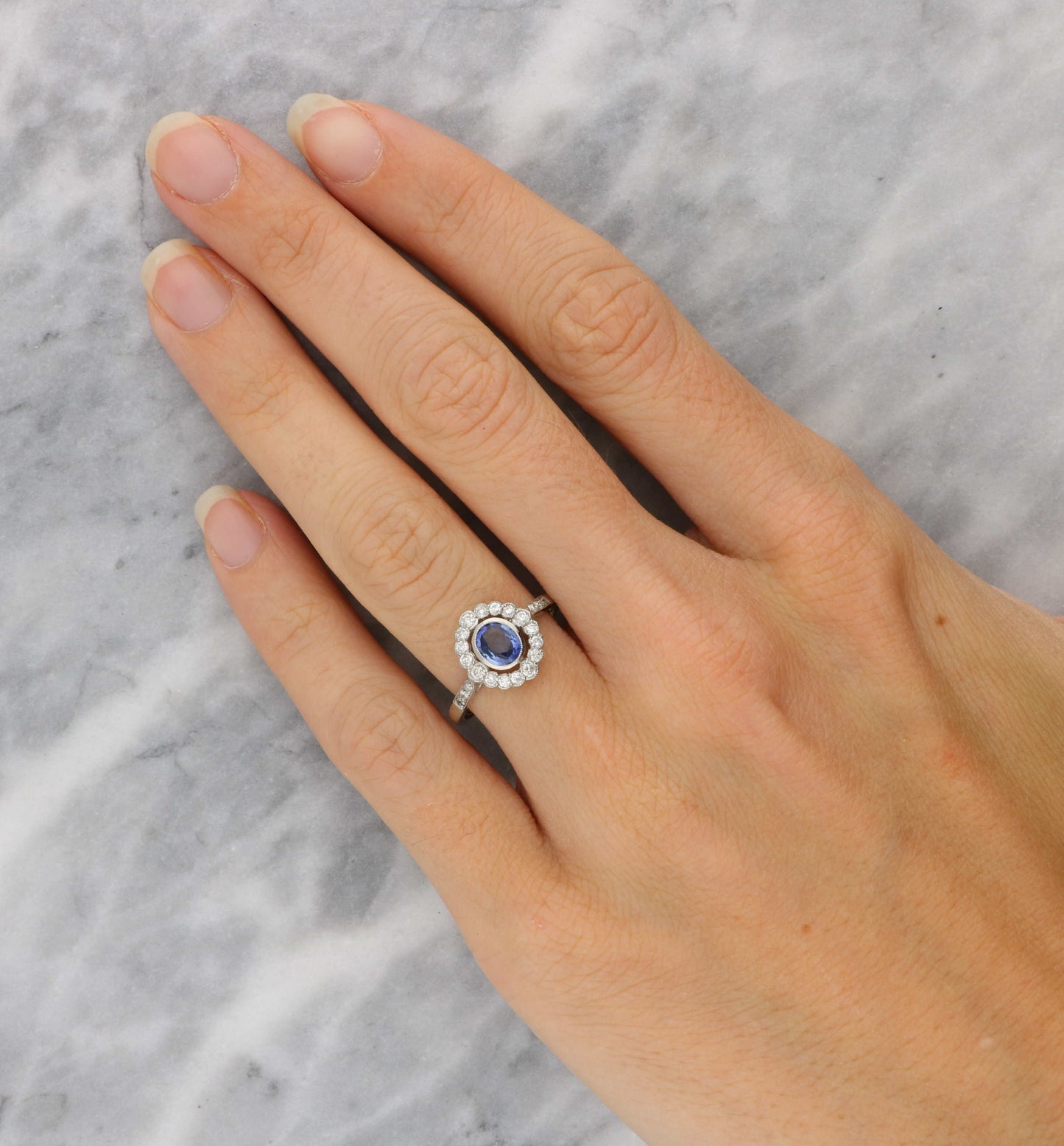 Platinum sapphire and diamond cluster engagement ring