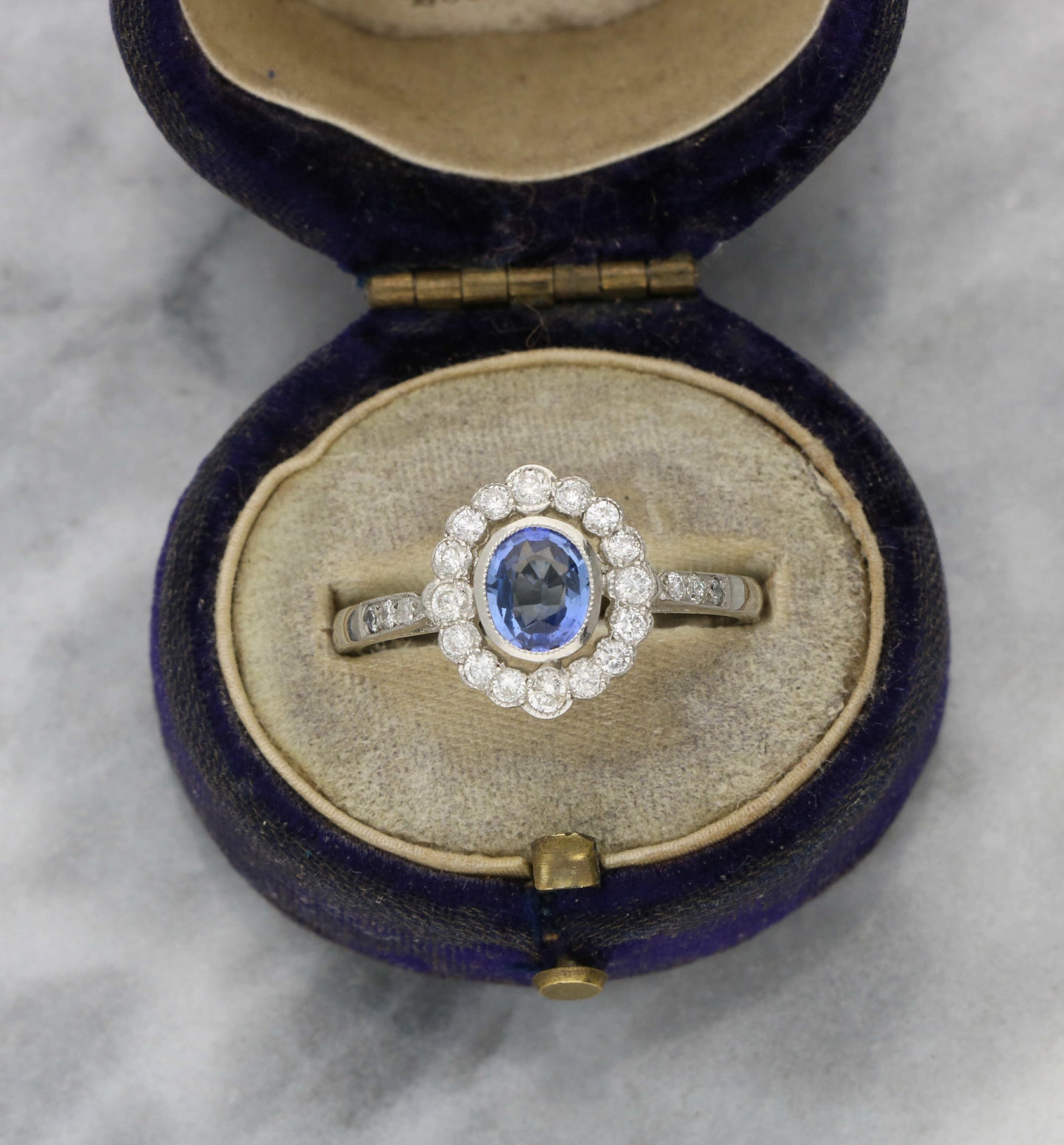 Platinum sapphire and diamond cluster engagement ring