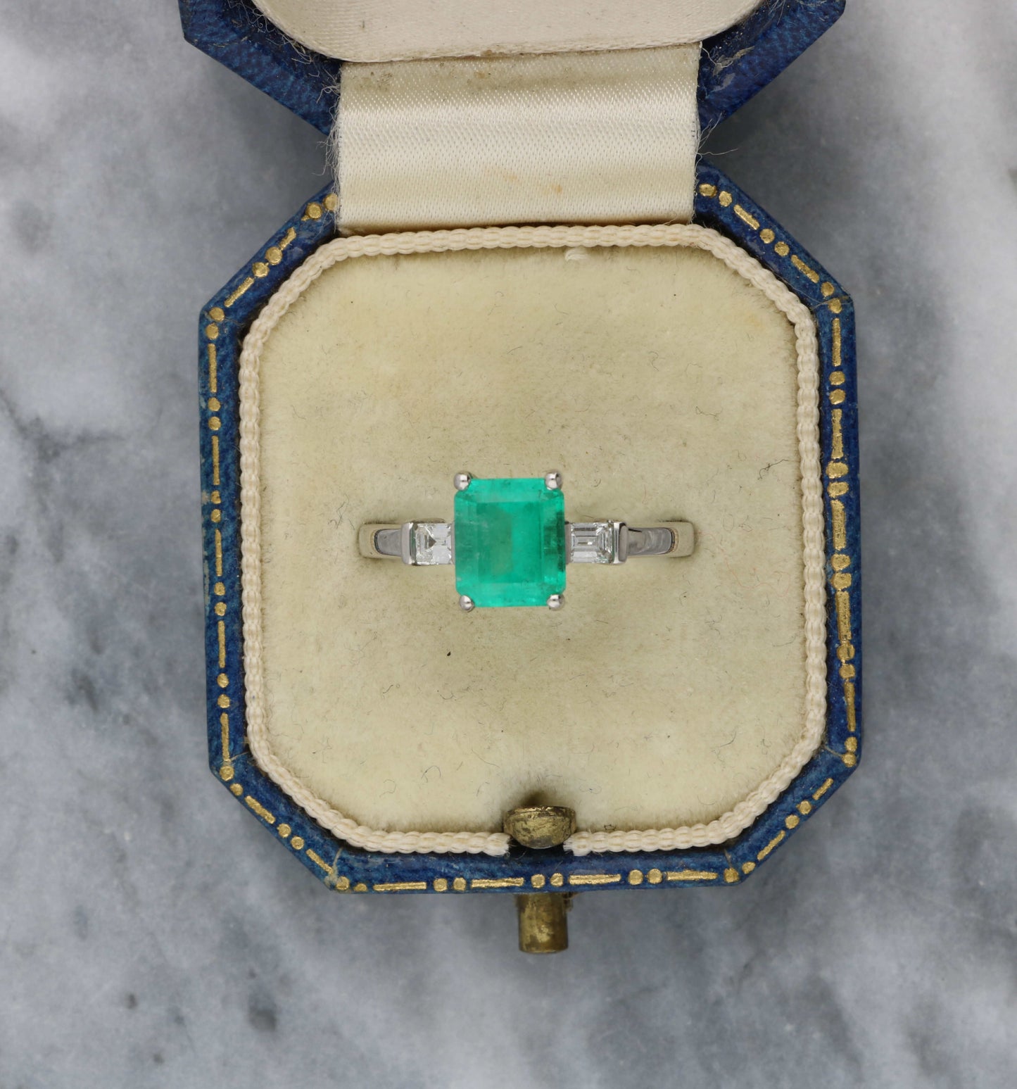 Platinum emerald and diamond engagement ring