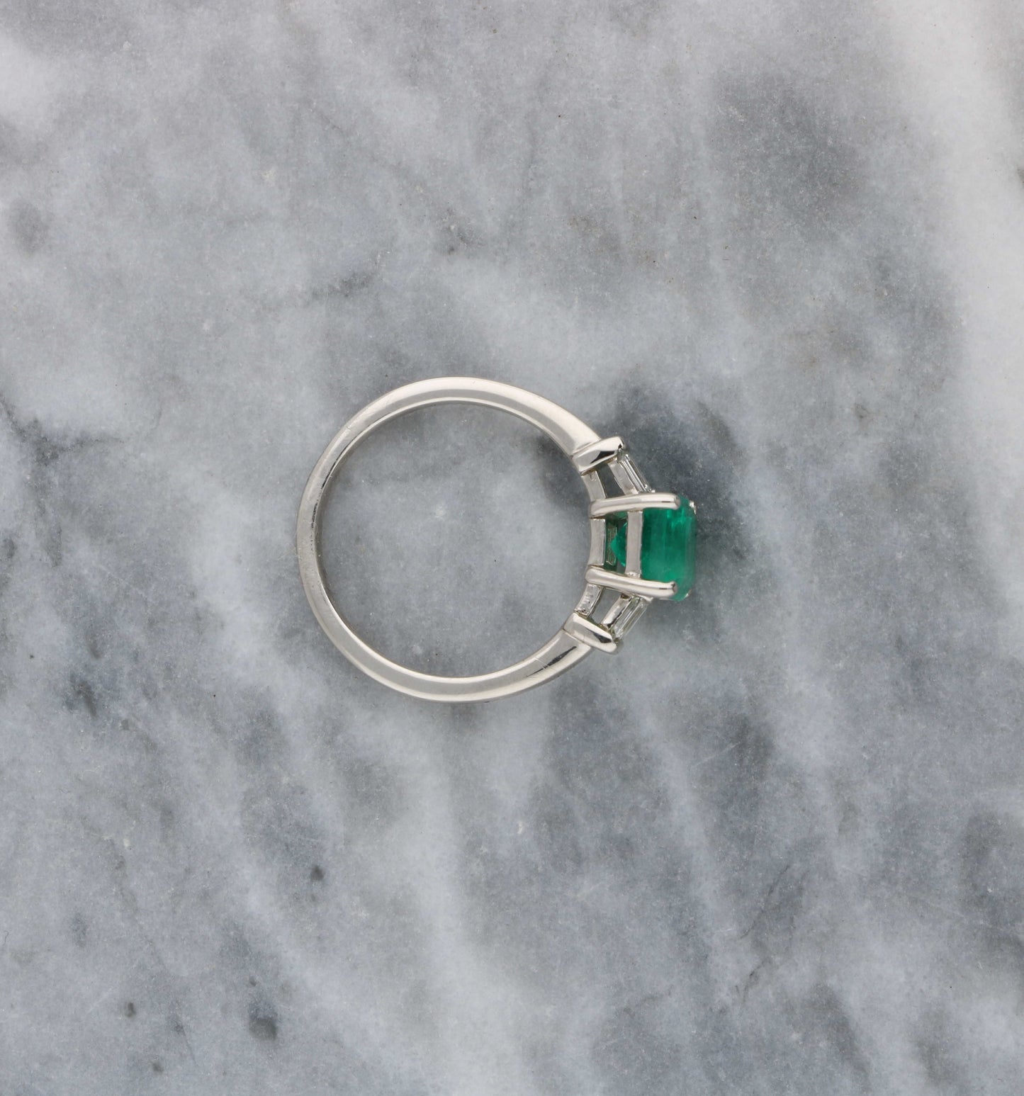Platinum emerald and diamond engagement ring