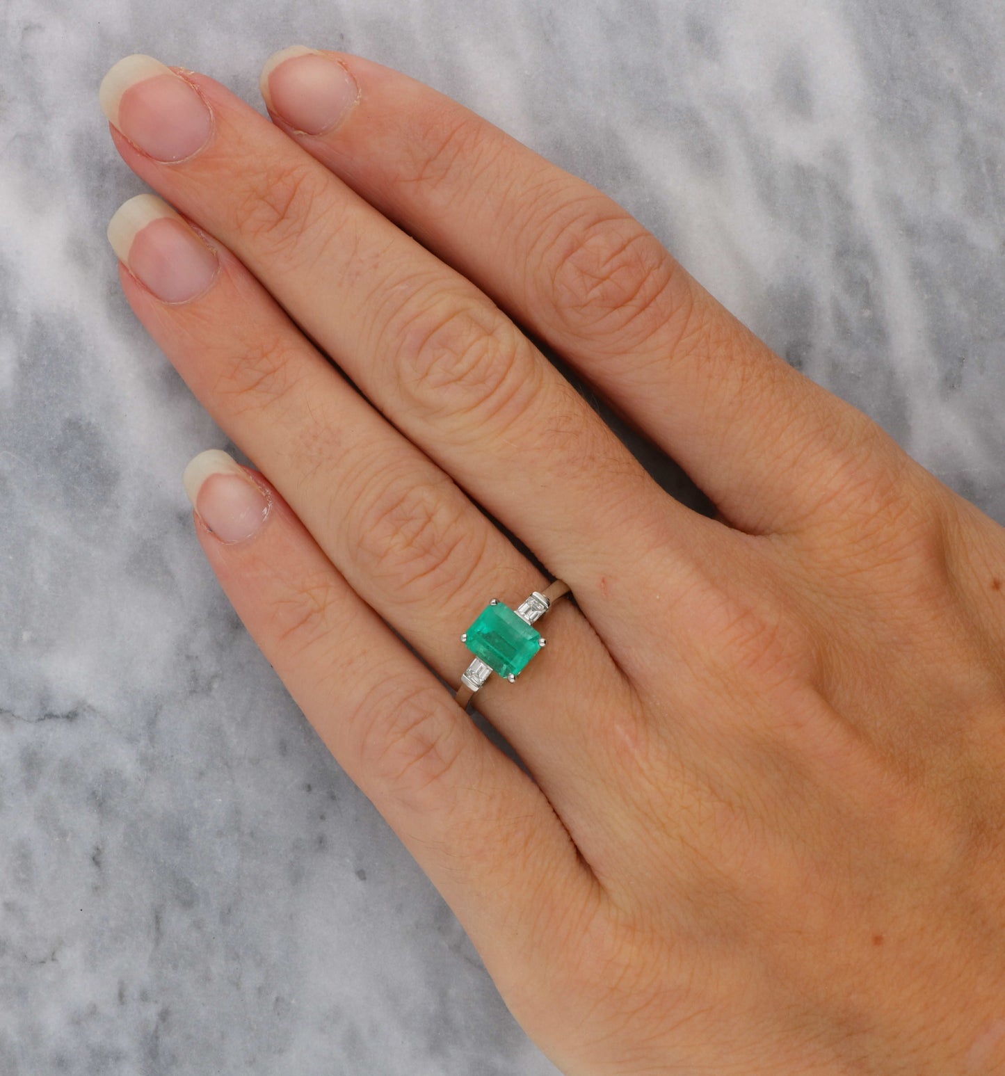 Platinum emerald and diamond engagement ring