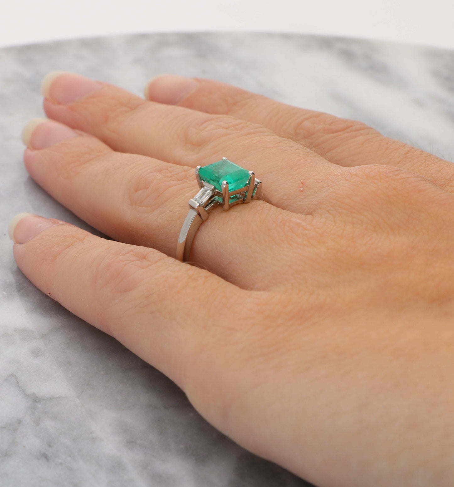Platinum emerald and diamond engagement ring