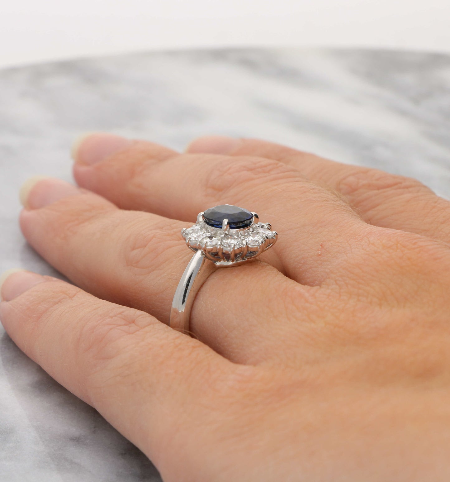 Platinum sapphire and diamond cluster engagement ring