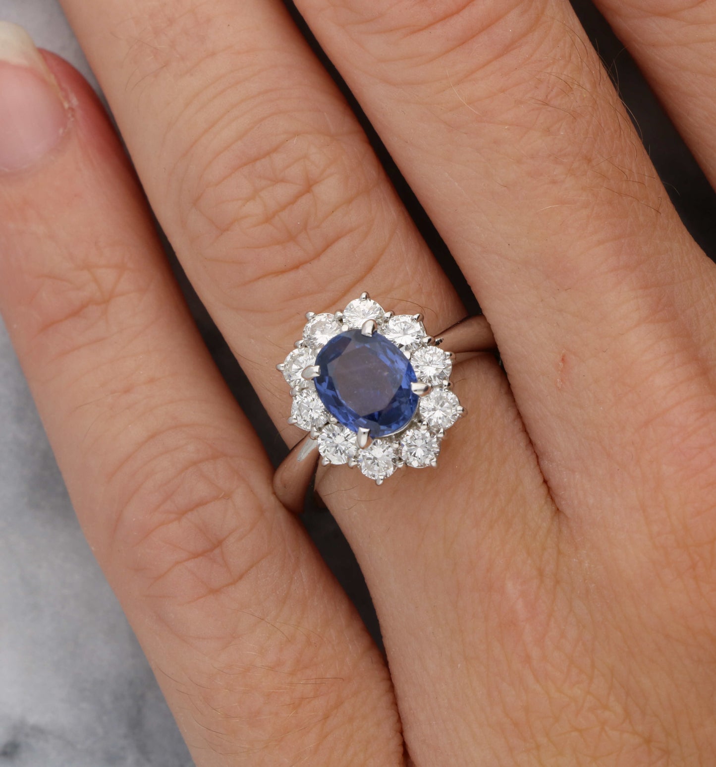 Platinum sapphire and diamond cluster engagement ring