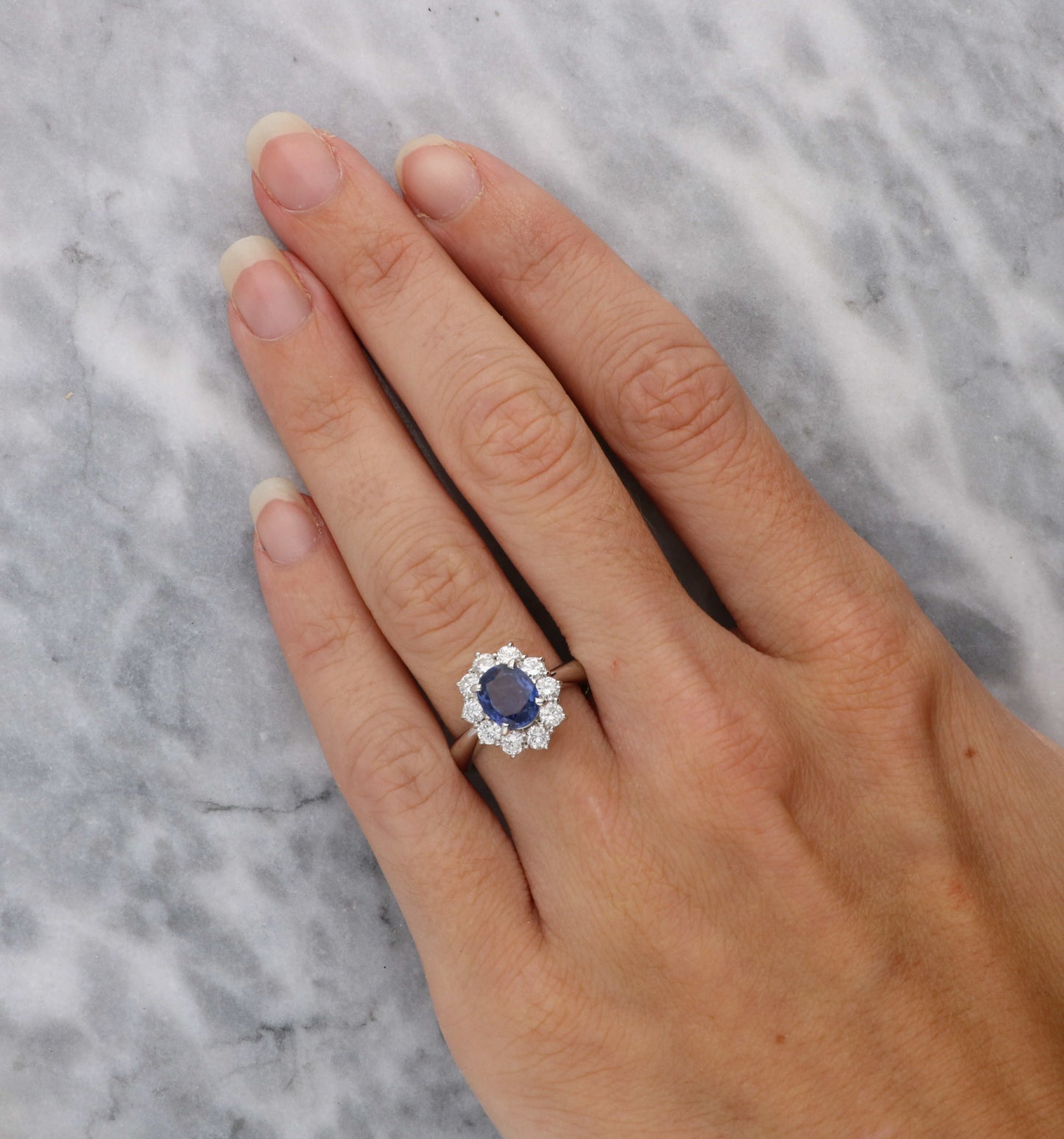 Platinum sapphire and diamond cluster engagement ring