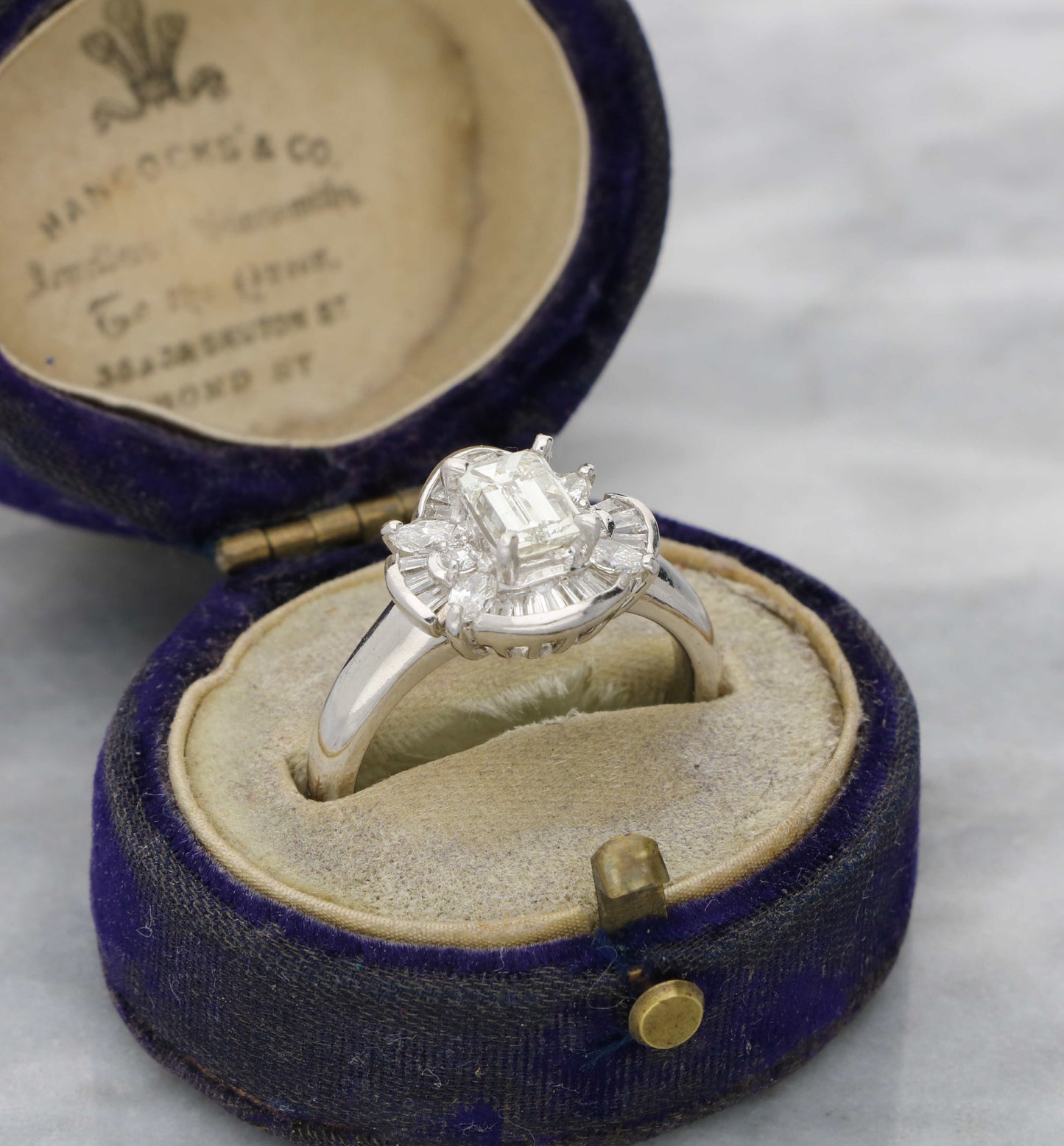 Platinum emerald-cut diamond cluster ring