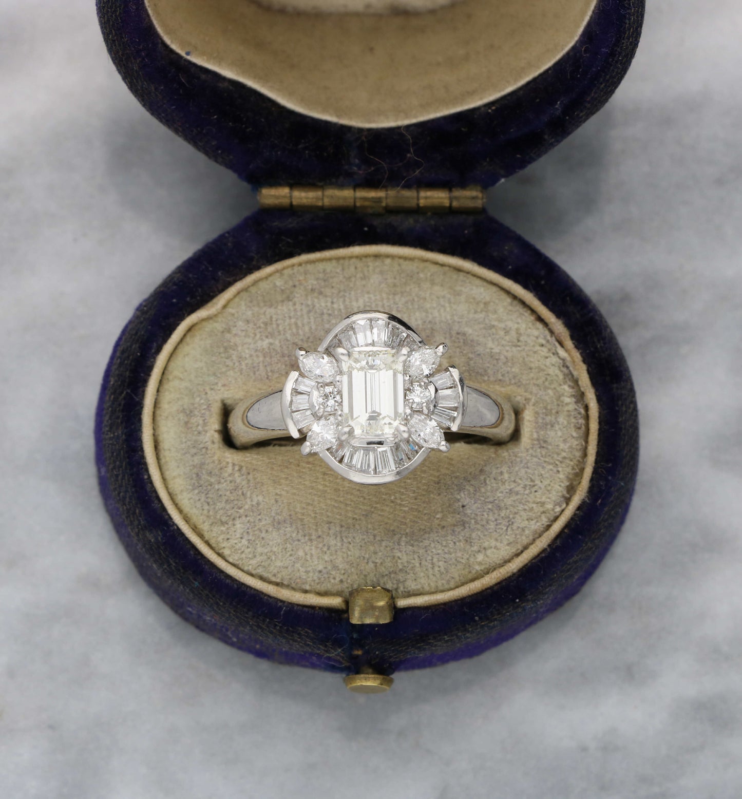 Platinum emerald-cut diamond cluster ring