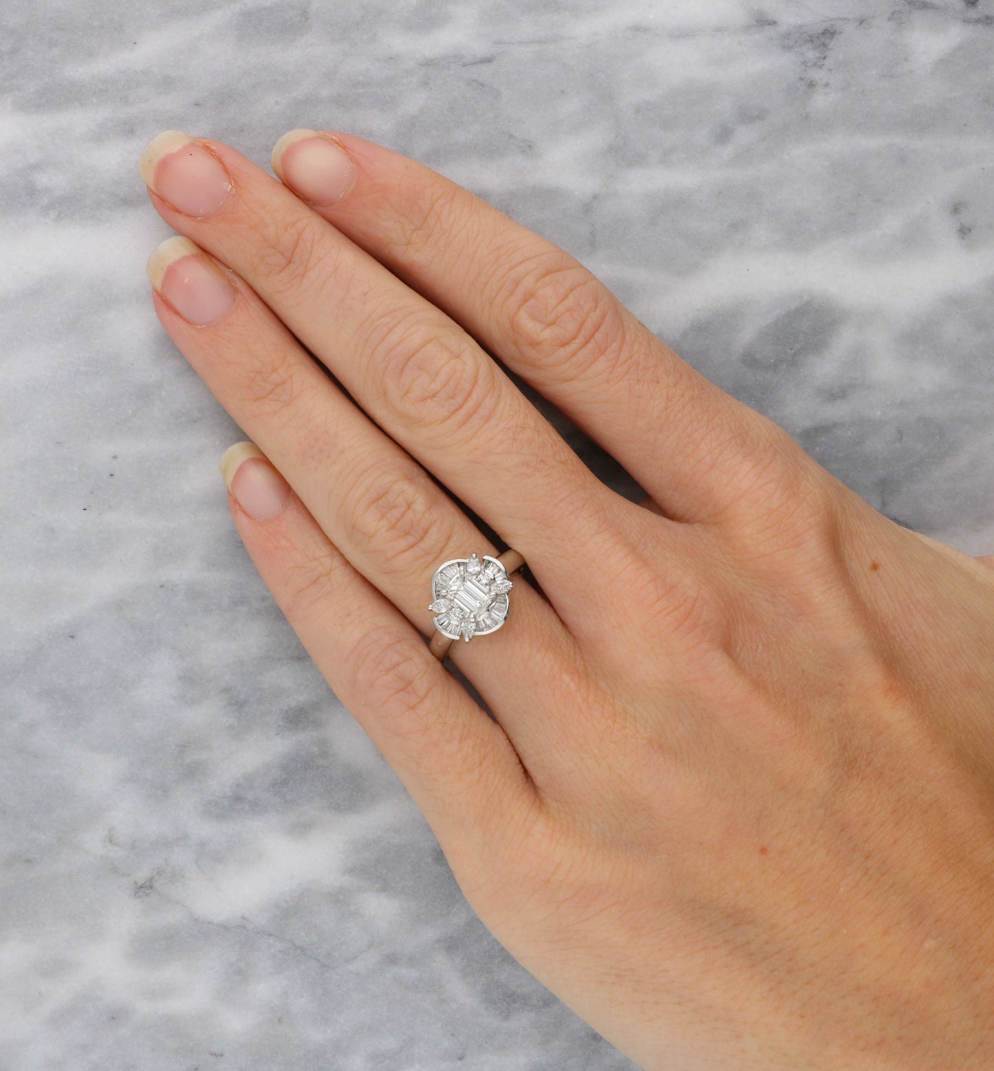Platinum emerald-cut diamond cluster ring