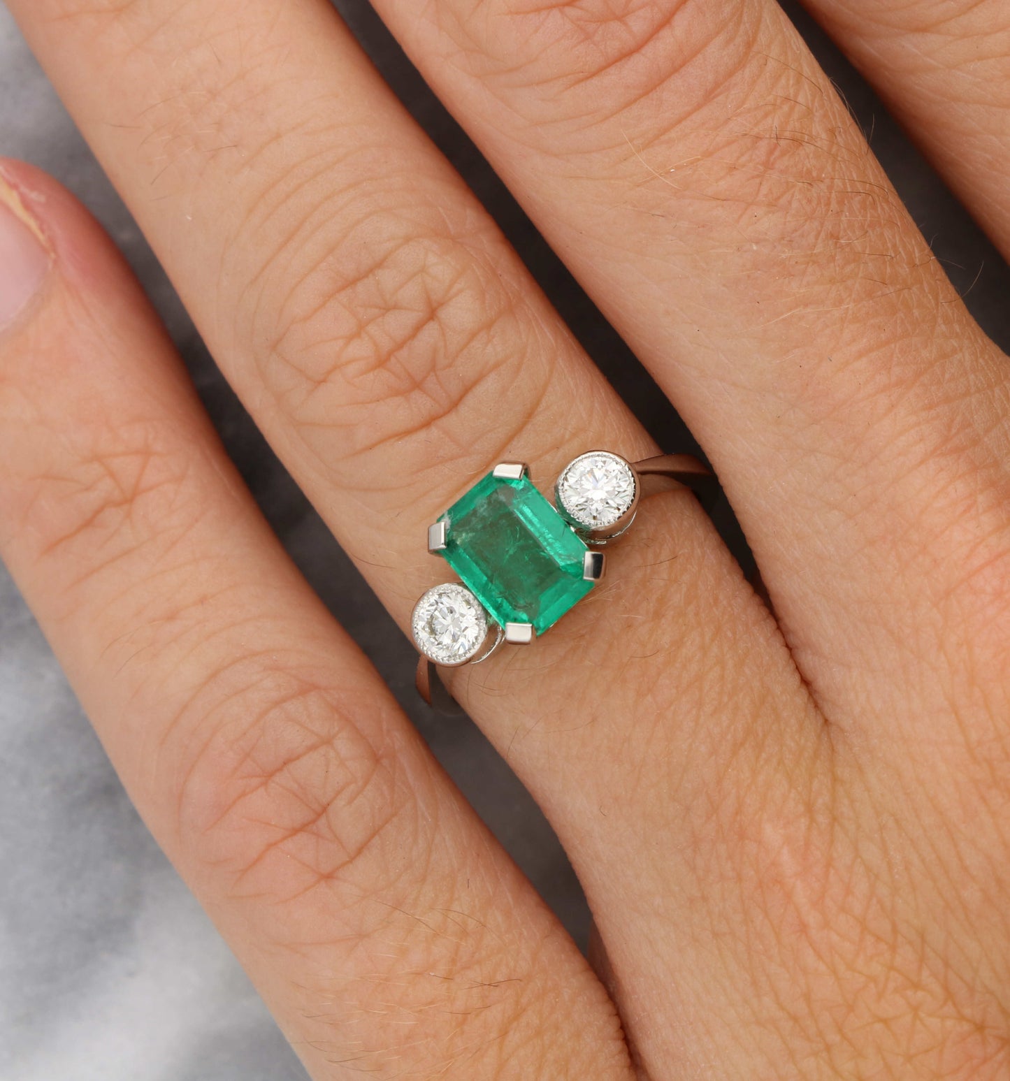 Platinum emerald and diamond 3 stone engagement ring