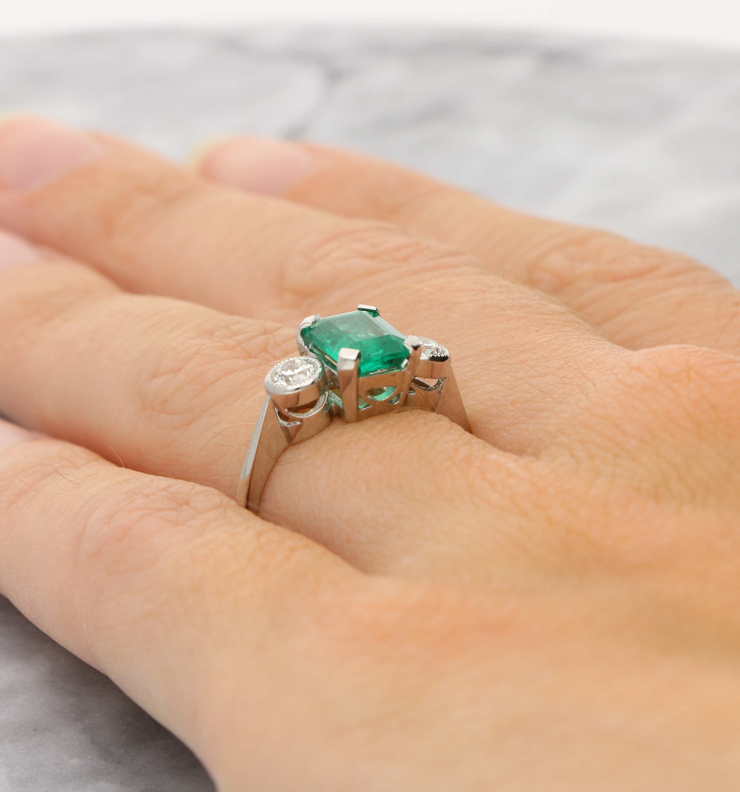 Platinum emerald and diamond 3 stone engagement ring