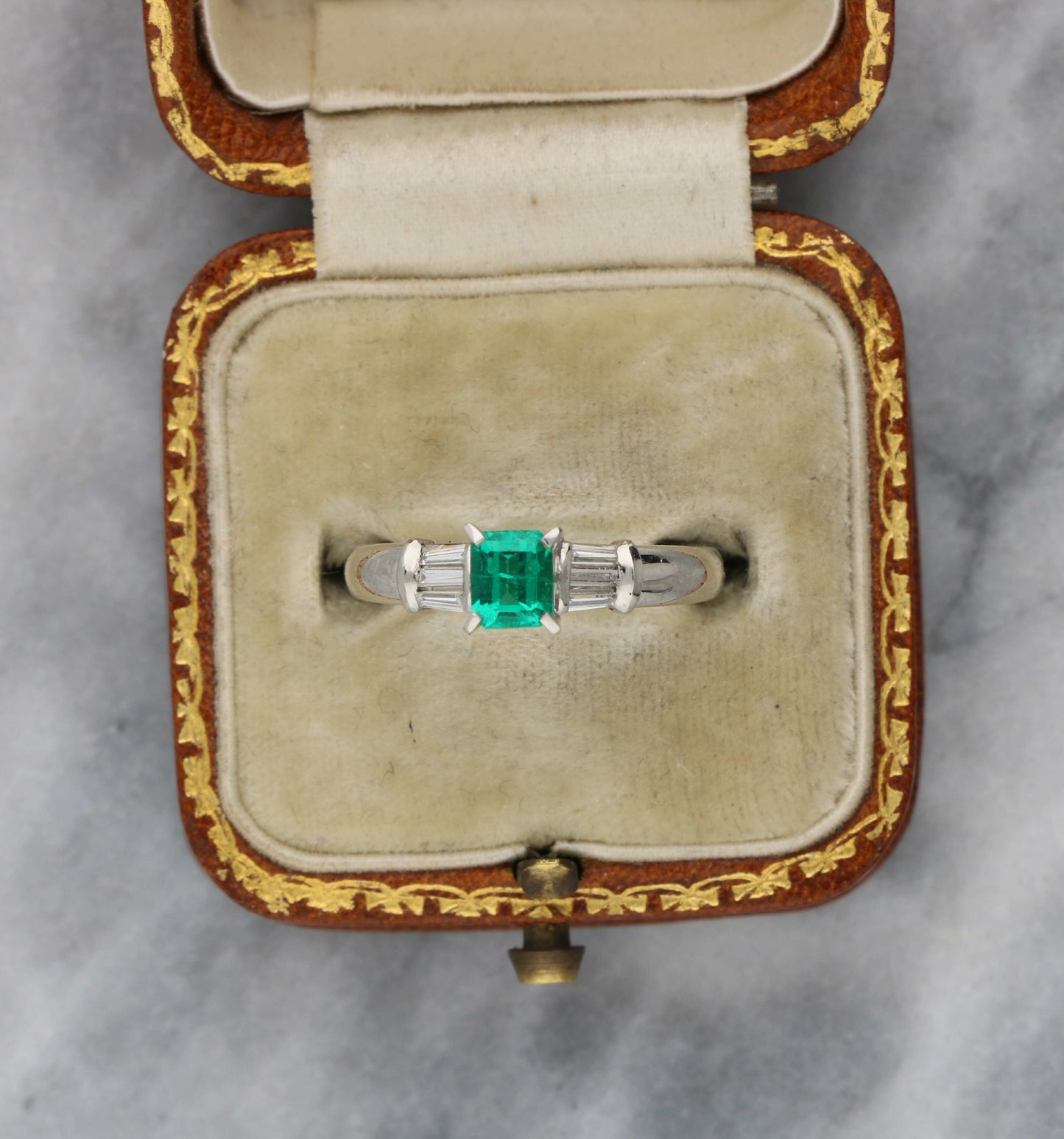 Platinum emerald and baguette diamond engagement ring
