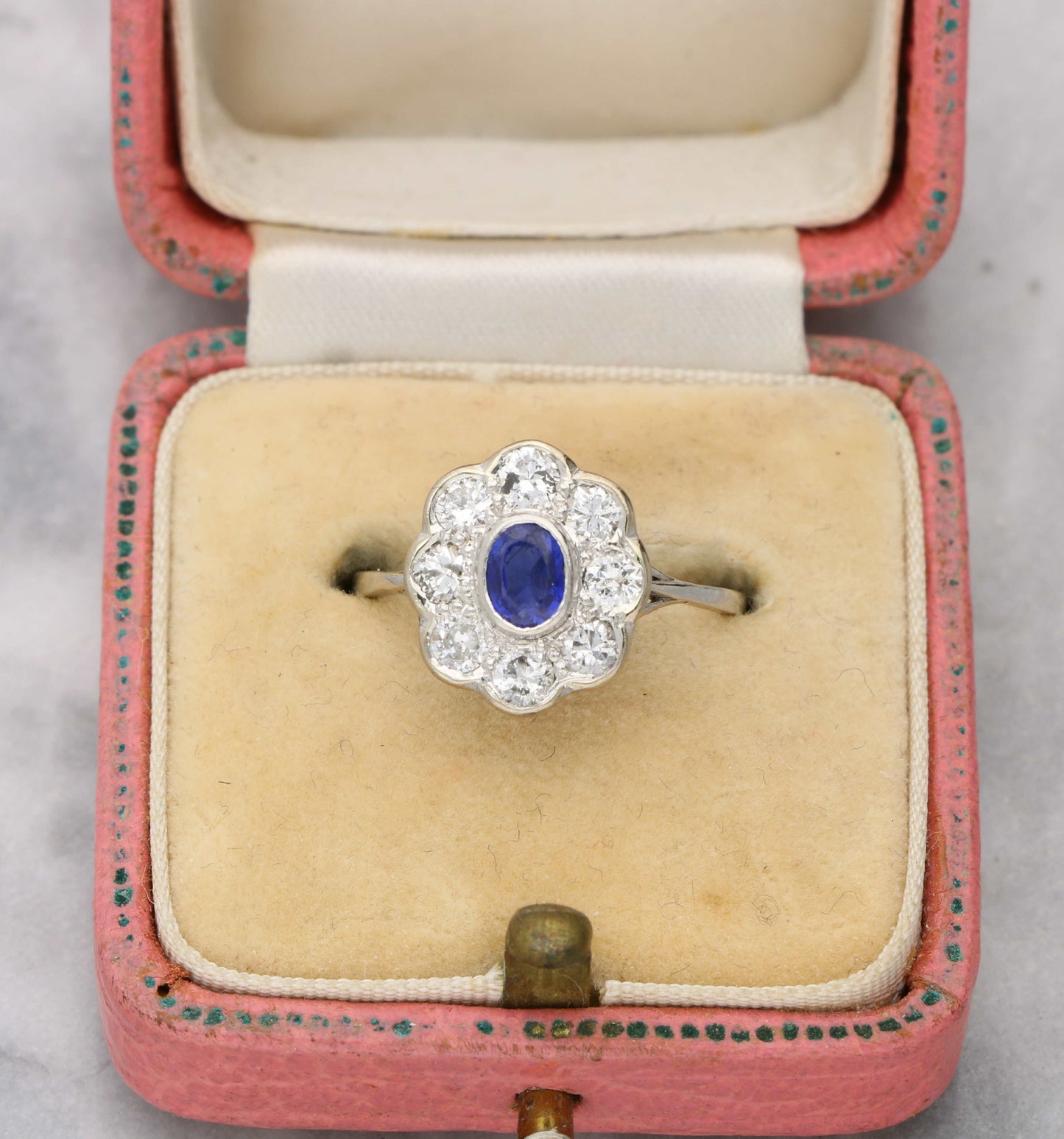 Sapphire and diamond cluster engagement ring