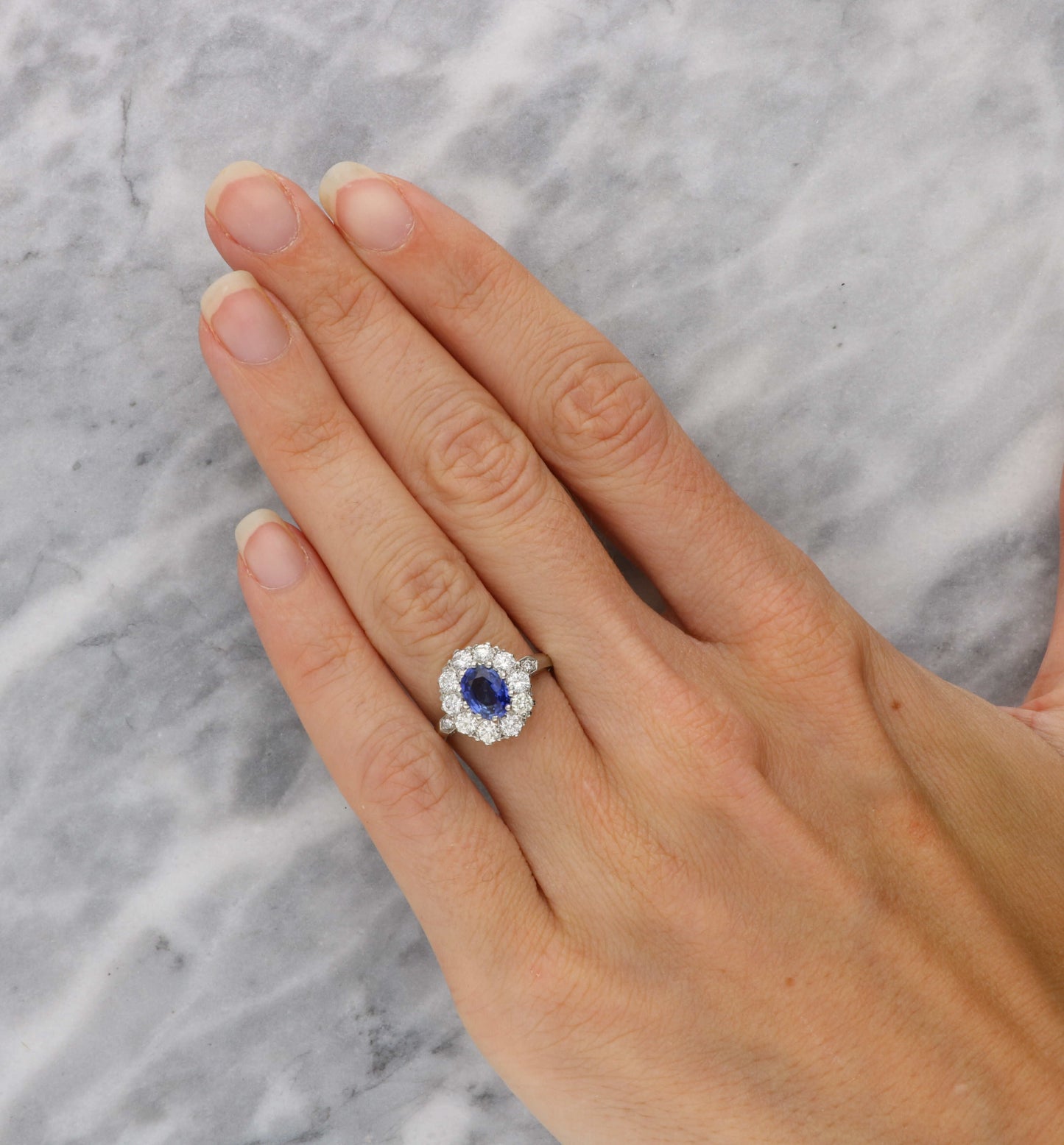 Platinum sapphire and diamond cluster engagement ring