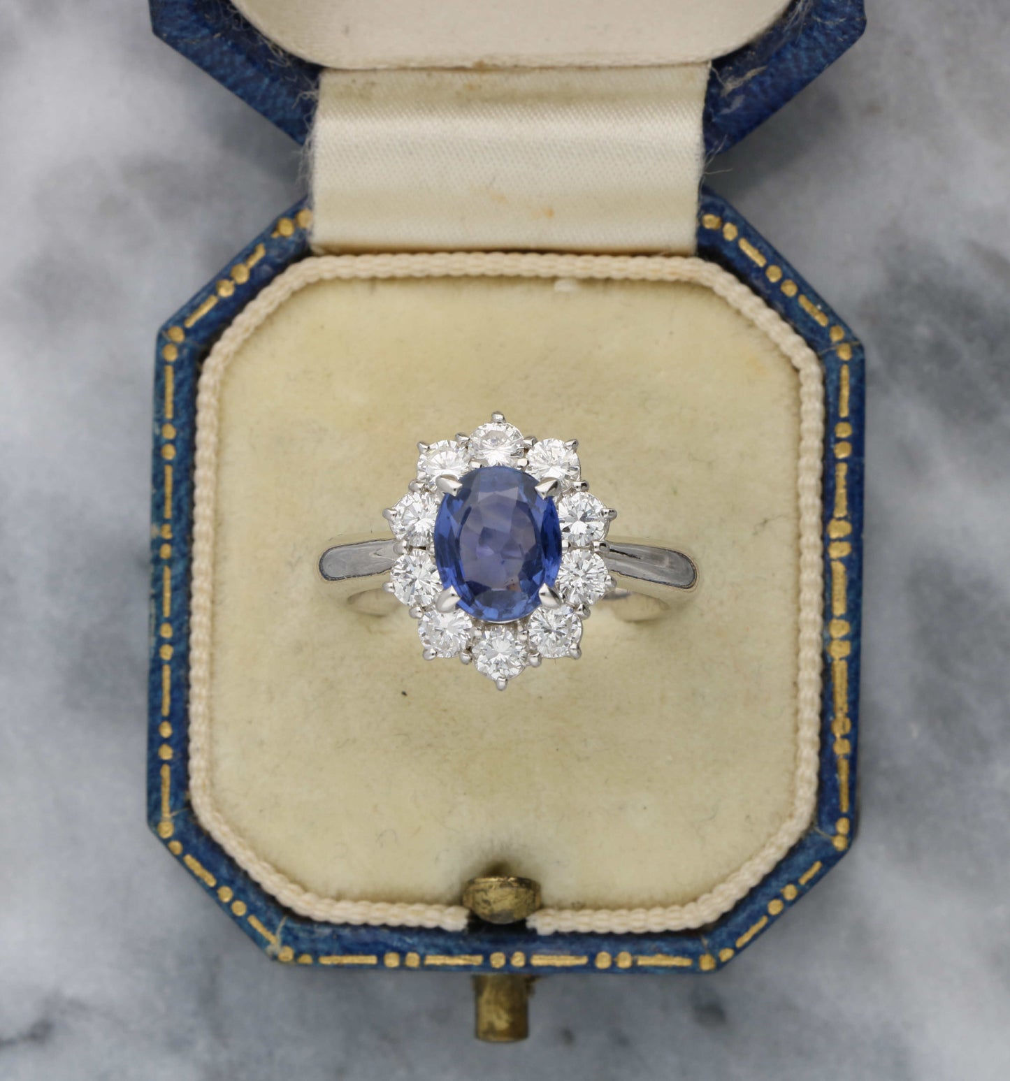 Platinum sapphire and diamond cluster engagement ring