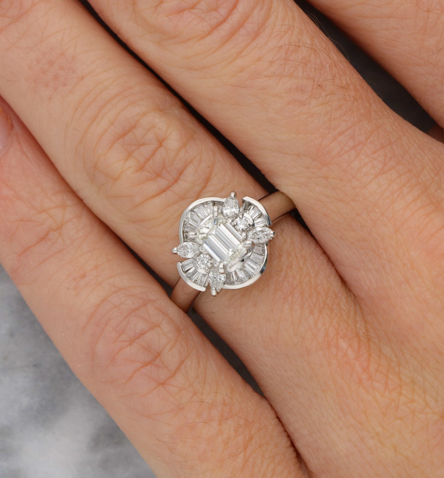 Platinum emerald-cut diamond cluster ring