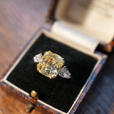 Diamond ring in an open jewelry box on a wooden surface