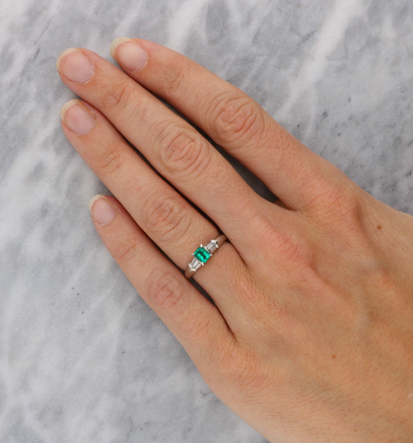 Platinum emerald and baguette diamond engagement ring