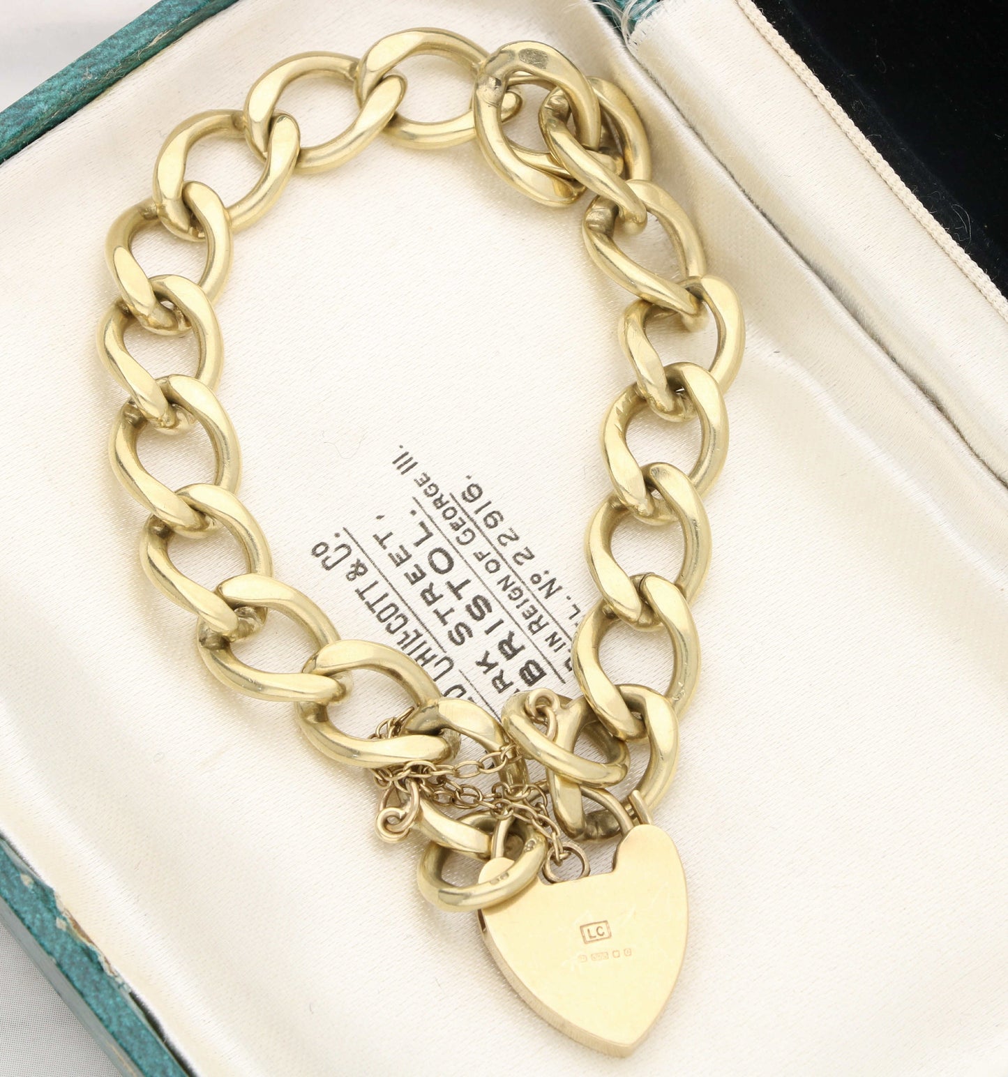 9ct gold curb bracelet with heart padlock.